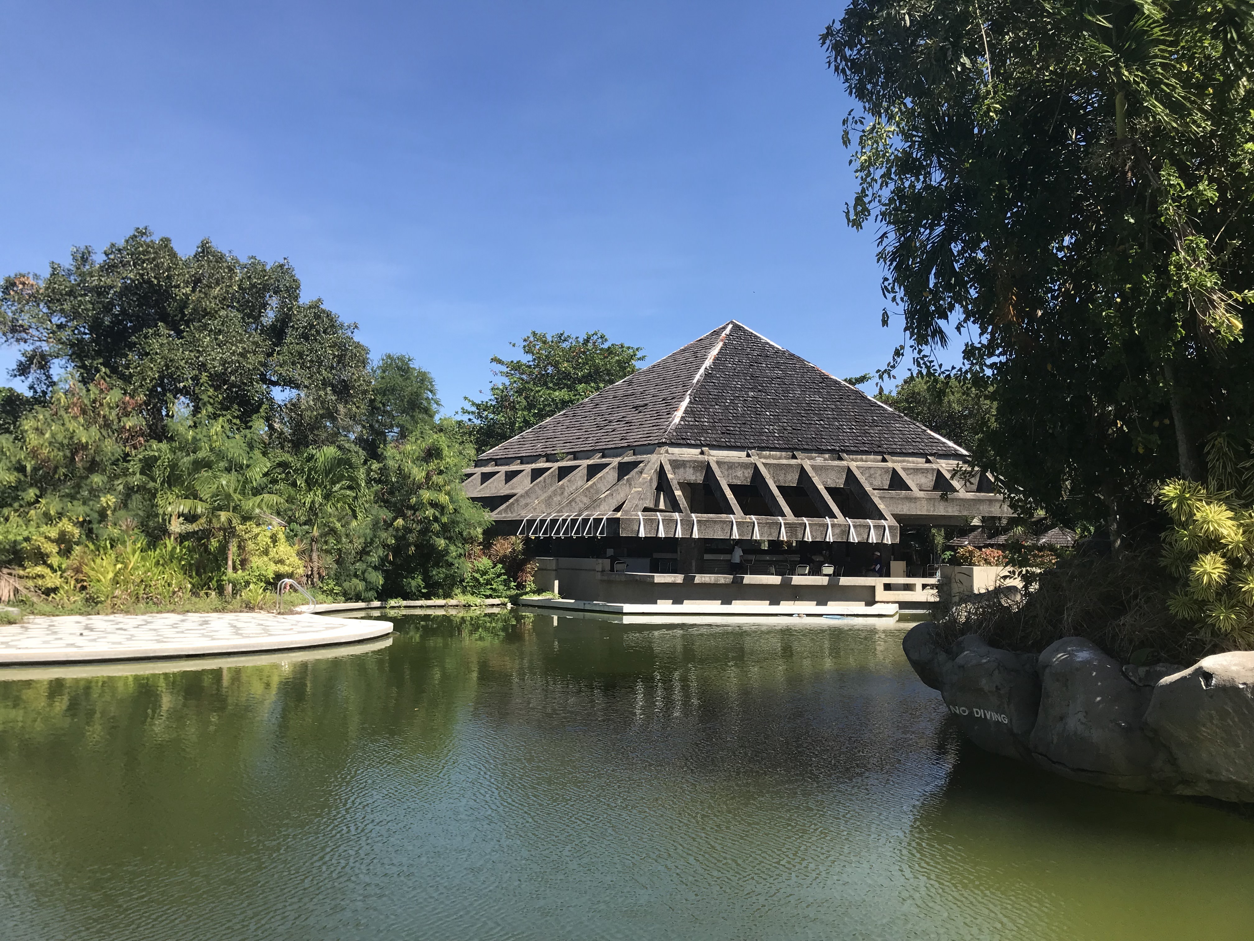 Abandoned clubhouse reflected in the pool at Puerto Azul, Ternate, Cavite