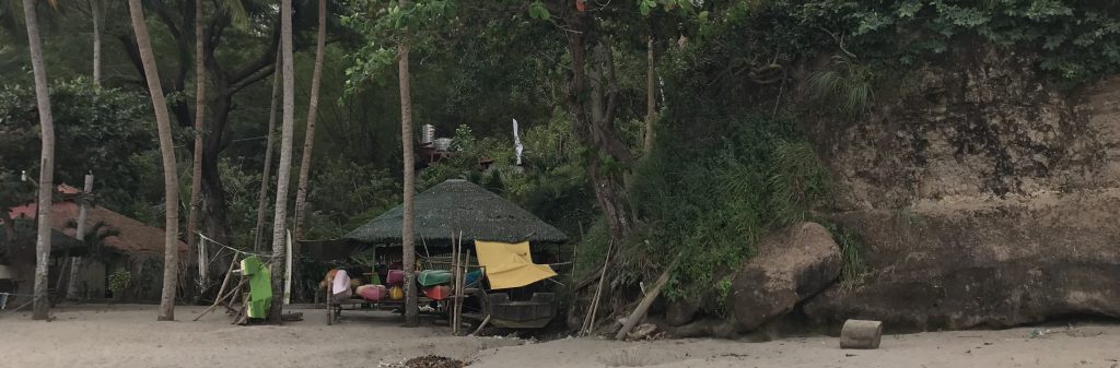 Cottages under the trees along the beach in Barangay Bucana, Ternate, Cavite