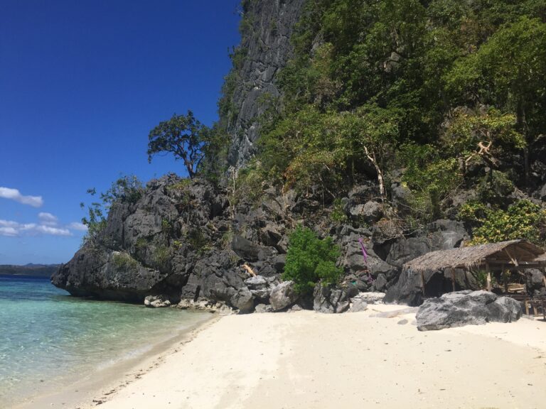 Beach 91, Limestone Cliffs with Nipa Huts in foreground