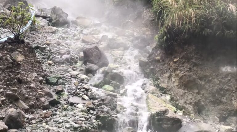 Hot water cascading over rocks at Baslay Hot Springs