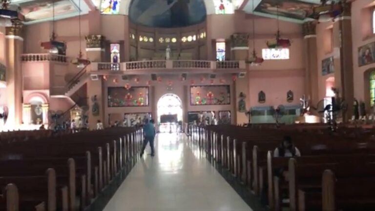 Rows of wooden pews and a polished aisle inside Binondo Church