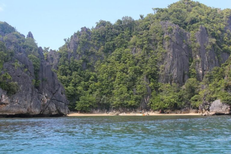 Small sandy beach beneath limestone cliffs on Cagbalinad Island, Caramoan