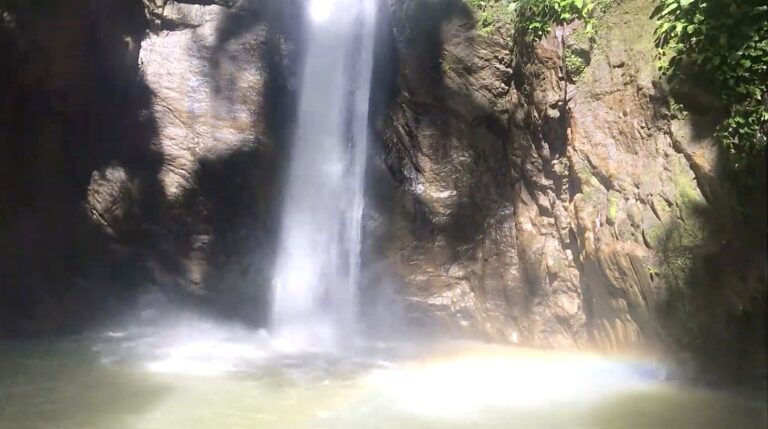 Casaroro Falls spray and a faint rainbow over the plunge pool in Negros Oriental