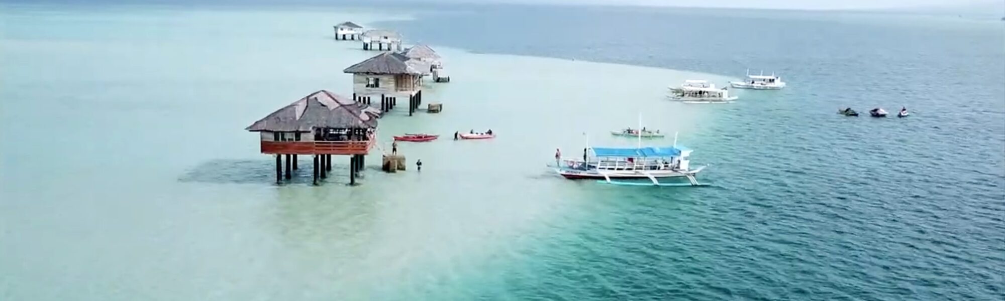 Aerial view of stilt cottages and boats on the Manjuyod Sandbar, Negros Oriental
