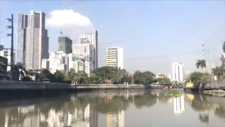 Pasig River with Manila high-rise buildings reflected in the water