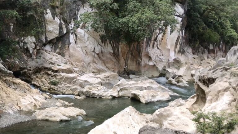 Limestone cliffs rising above the turquoise water at Tinipak River in Tanay, Rizal