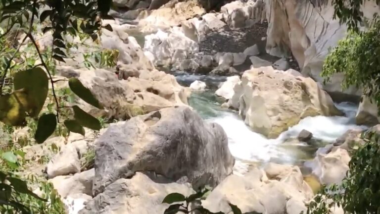 White water rushing between limestone boulders on Tinipak River